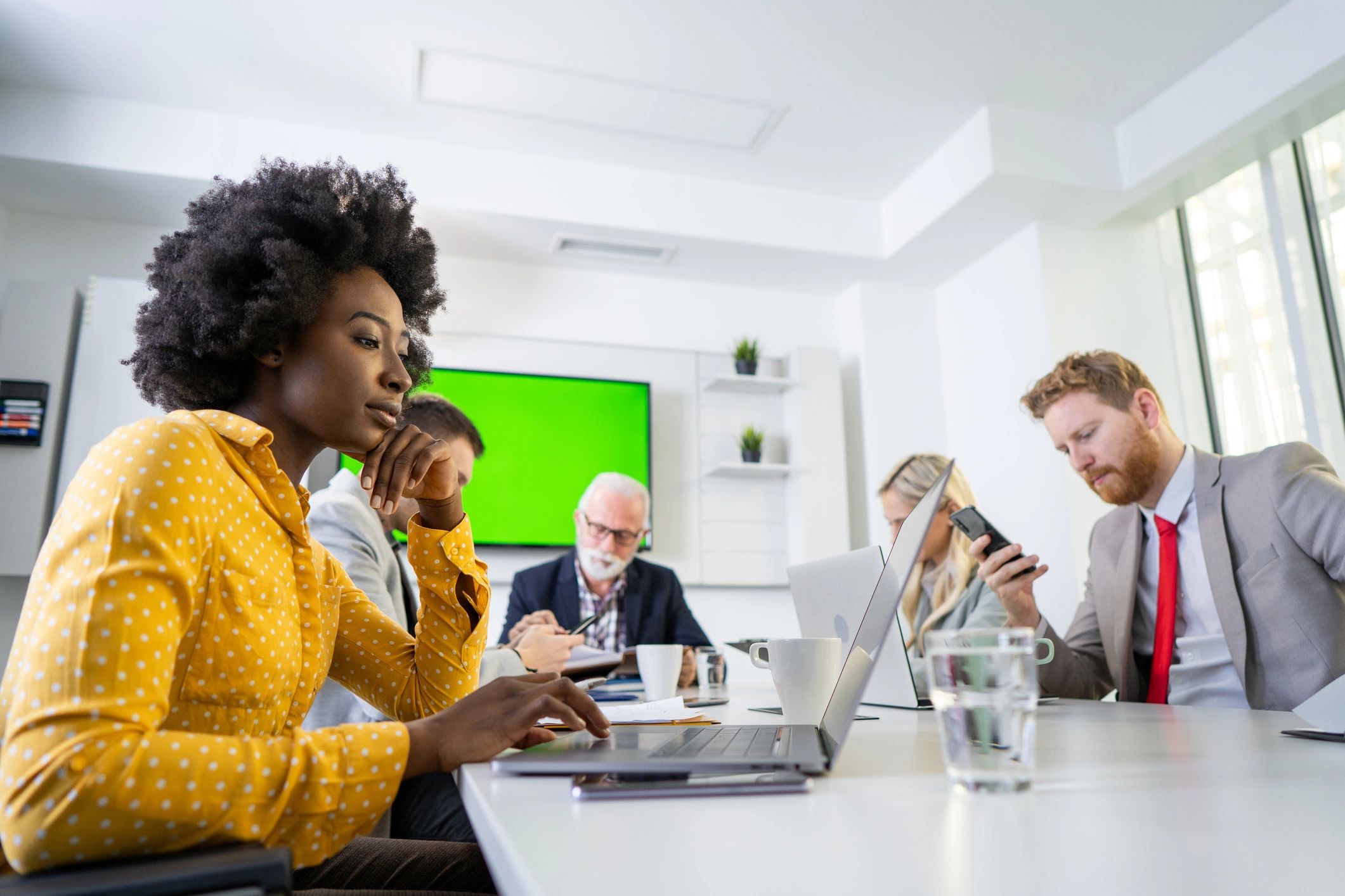 Editorial team collaborating in a newsroom meeting