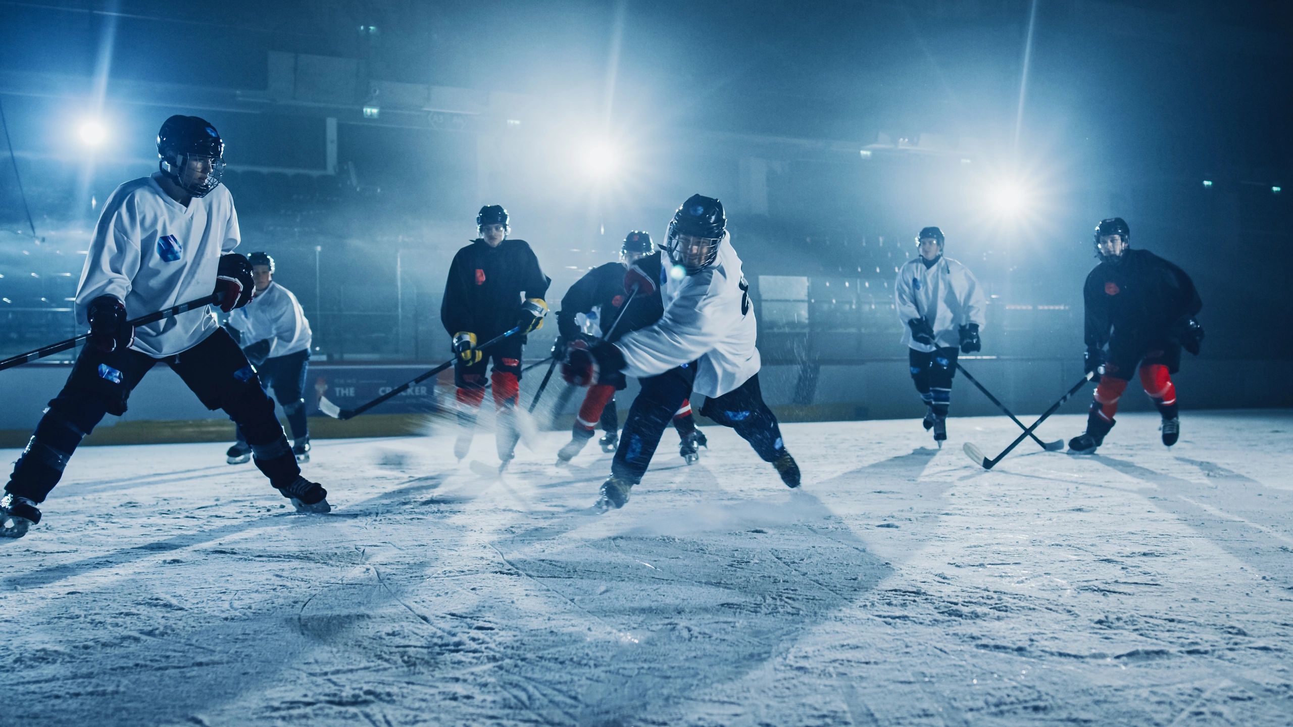 Ice hockey player taking a powerful shot in an arena