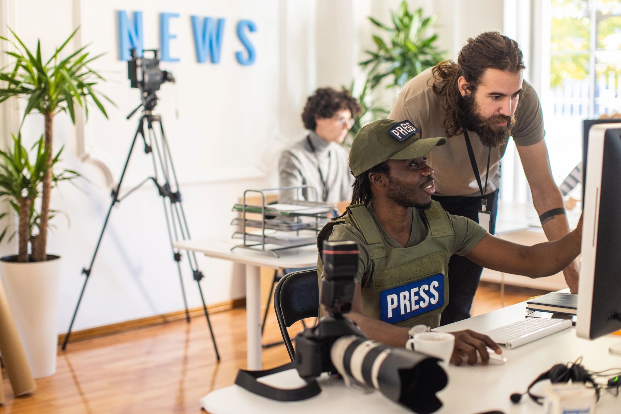 Reporter reviewing images and story assets in the newsroom